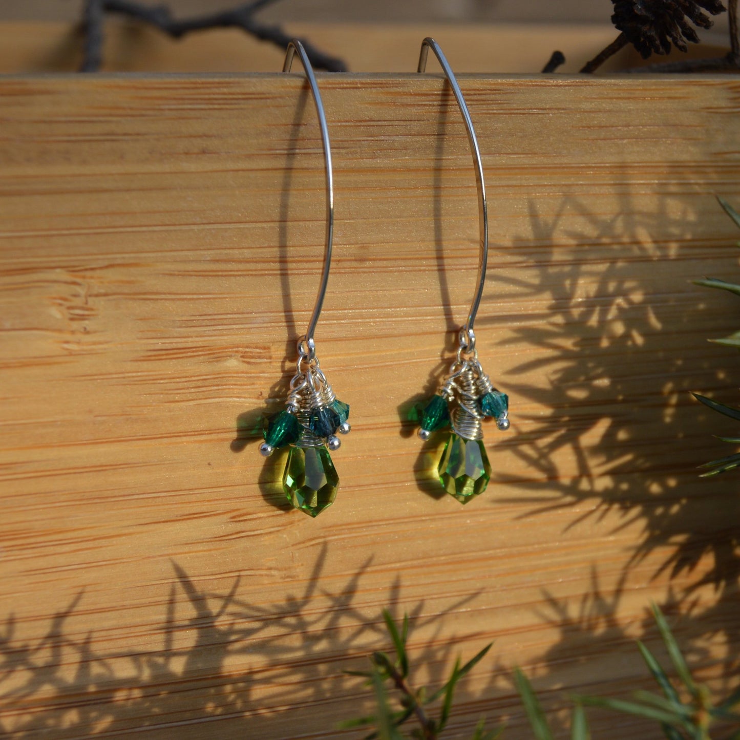 Sterling silver earrings with faceted Czech glass crystals in green & blue tones.