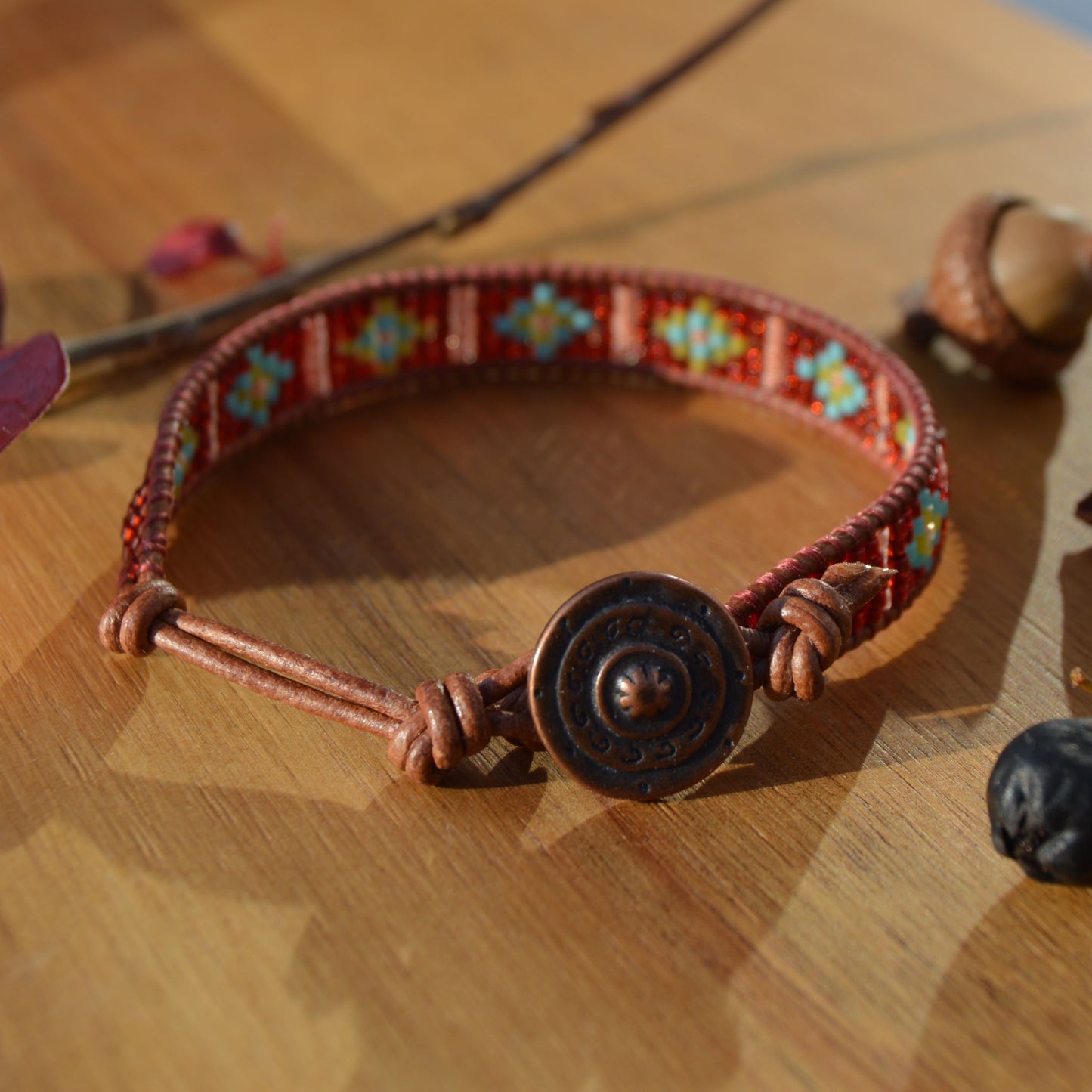 Leather wrap seed beads bracelet with button in copper colour as a lock and extension in leather.