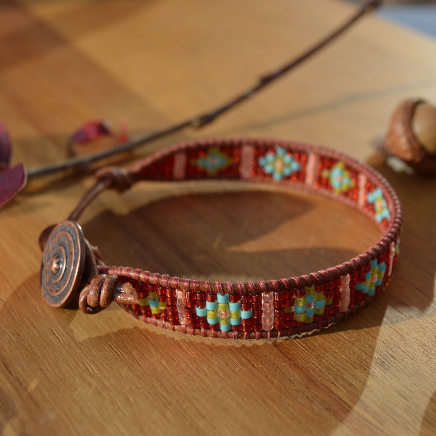 Leather wrap seed beads bracelet with button in copper colour as a lock and extension in leather.